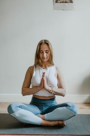 Woman doing a yoga pose and meditation